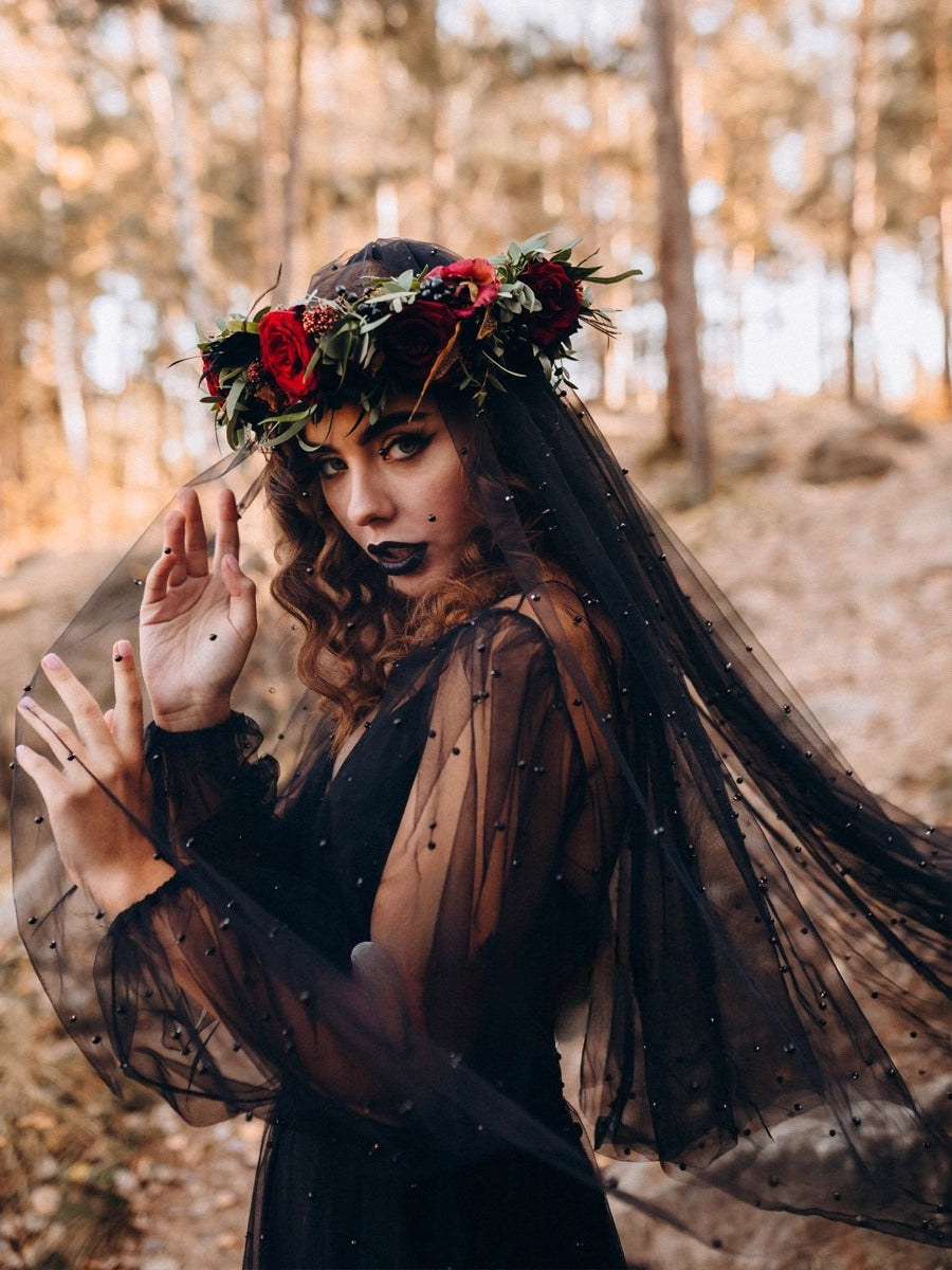 This design redefines traditional bridal elegance with a dark, romantic twist. Featuring lustrous black pearls delicately adorning a sheer veil, it captures a hauntingly beautiful aesthetic. Perfect for vintage photoshoots, it adds a touch of gothic rebellion to bridal portraits. As a Halloween accessory, it embodies the mystical "witch bride" persona, blending drama, mystery, and timeless sophistication.