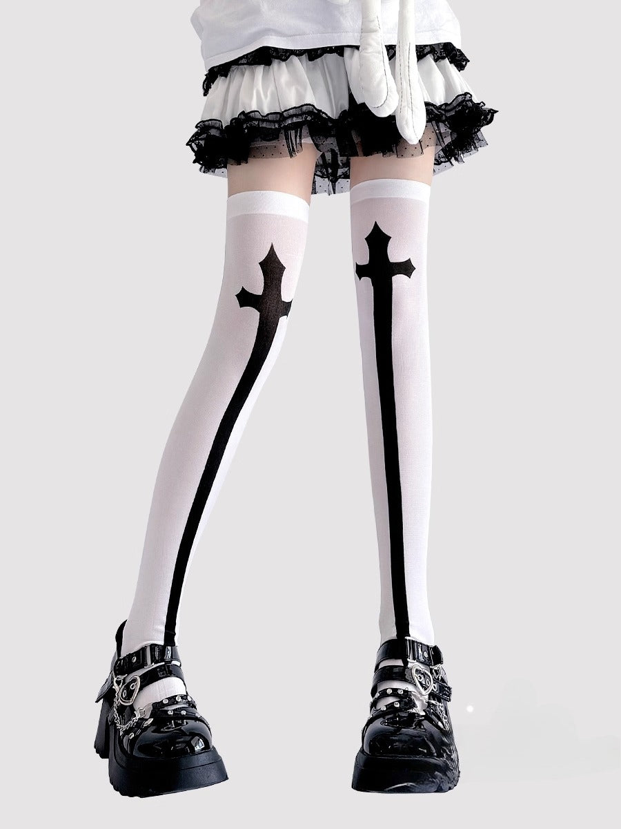 Inspired by the rebellious fusion of gothic punk and JK fashion, these thigh-high socks blend dark elegance with subcultural edge. The stark black-and-white contrast and symbolic cross motifs evoke a provocative yet sophisticated vibe. Perfect for Halloween events, cosplay, or streetwear statements, they embody a fearless expression of alternative style with a touch of daring allure.