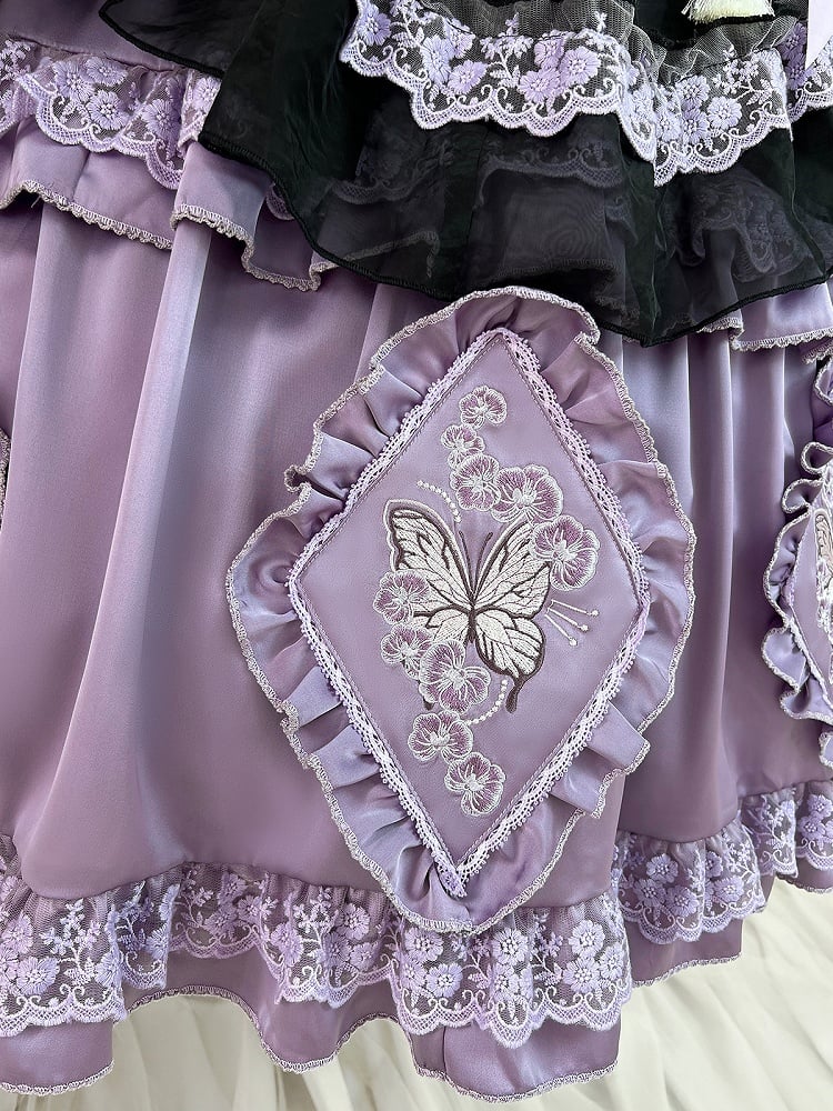 The Classic Purple Han Lolita Dress Set is designed to blend traditional elegance with Lolita sweetness. Featuring delicate butterfly and floral embroidery, it showcases refined craftsmanship and a graceful silhouette. The rich purple tone conveys nobility and charm, while the contrasting black apron adds depth and vintage flair. Perfect for cultural events, tea parties, or special gatherings, this full set reflects the harmonious fusion of Han-inspired beauty and Lolita fashion.