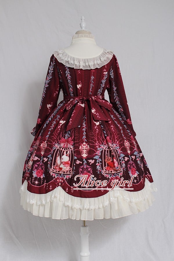 The Red Classic Lolita OP Dress is designed to express timeless elegance with a sweet touch. Featuring long sleeves for autumn and winter wear, it is adorned with delicate lace and charming bow tie details that highlight femininity. The fitted bodice with lace-up accents creates a graceful silhouette, while the rich red tone conveys warmth and sophistication. Perfect for tea parties, gatherings, or seasonal occasions, this dress captures the romantic spirit of classic Lolita fashion.