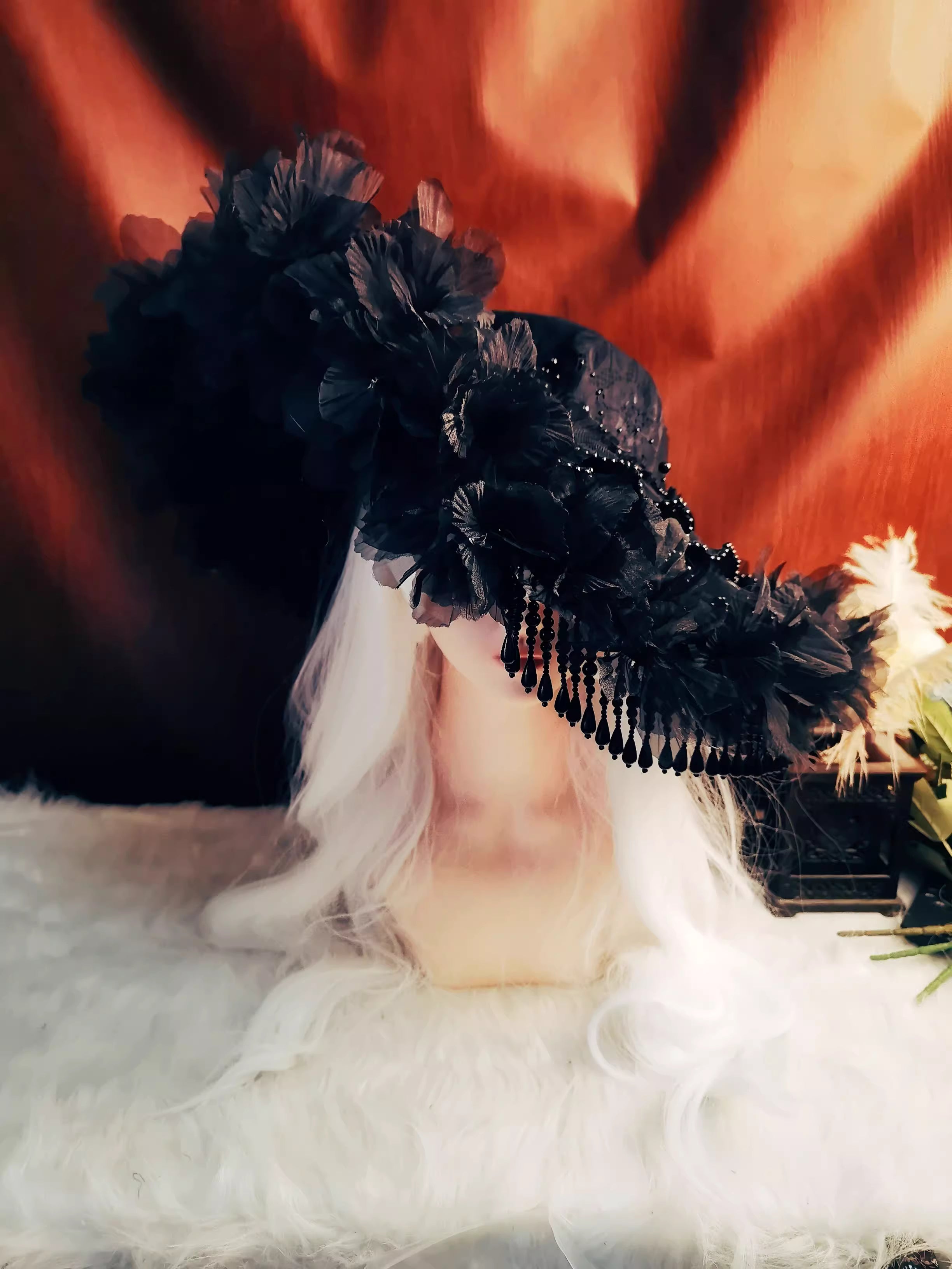 This handmade gothic Lolita widow hat embodies dark elegance with black pearls, lace, roses, and feather details. Designed for dramatic flair, it blends vintage mourning aesthetics with Lolita sophistication. The tassel accents add graceful movement, while the floral and feather elements enhance its mysterious charm. Perfect for Halloween, cosplay, or gothic fashion styling, it completes any hauntingly elegant look.
