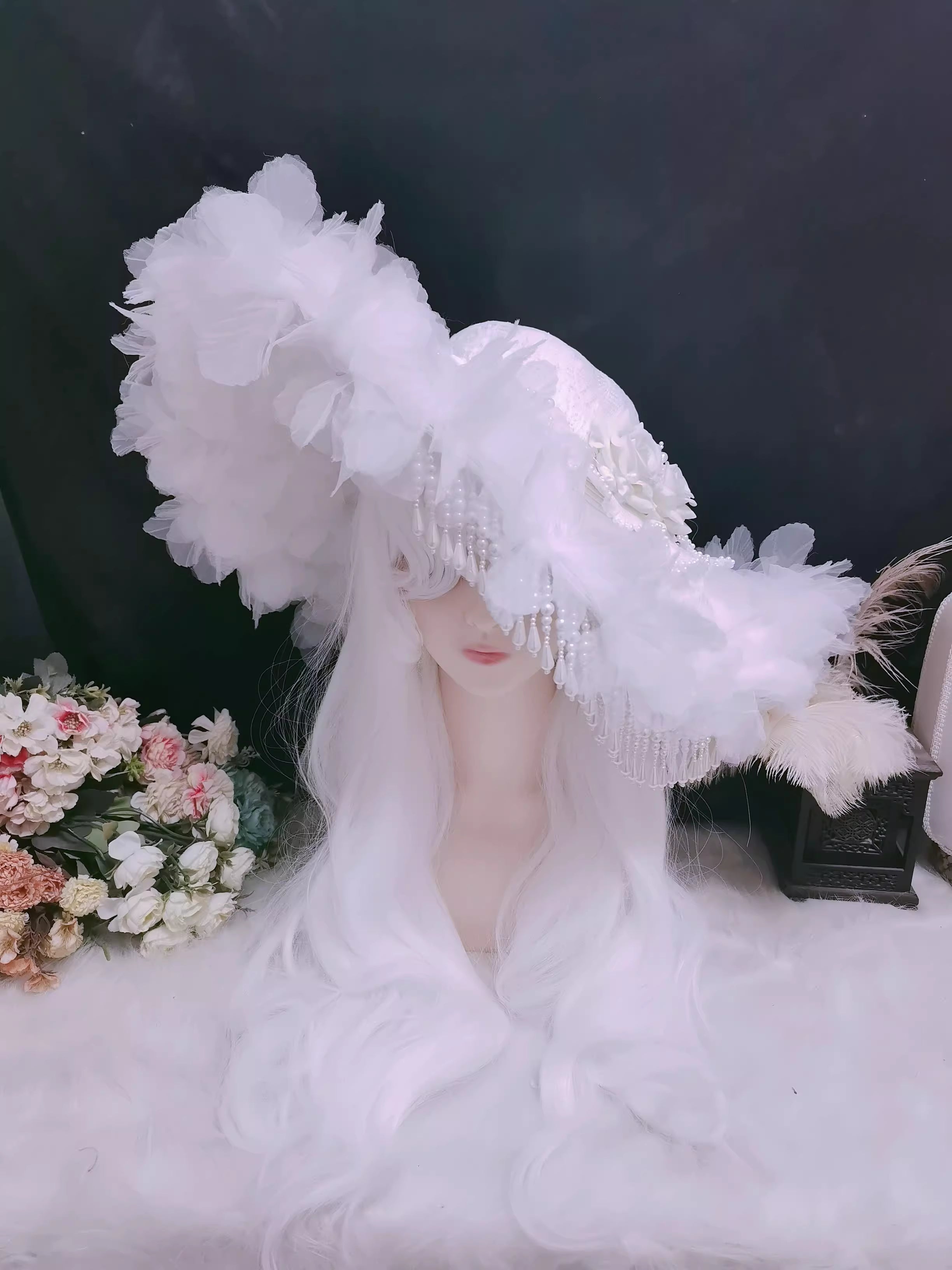 This handmade gothic Lolita widow hat embodies dark elegance with black pearls, lace, roses, and feather details. Designed for dramatic flair, it blends vintage mourning aesthetics with Lolita sophistication. The tassel accents add graceful movement, while the floral and feather elements enhance its mysterious charm. Perfect for Halloween, cosplay, or gothic fashion styling, it completes any hauntingly elegant look.