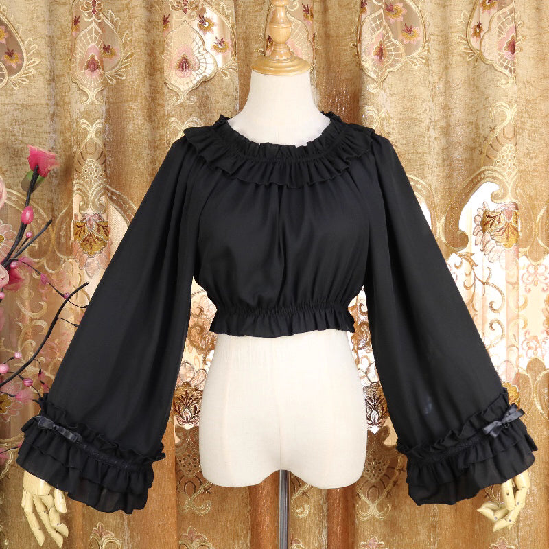 This flowing chiffon blouse combines delicate details with dramatic flared sleeves. Rendered in classic black, white, and bold red, its loose round neck design offers comfortable versatility for layering under JSKs or jumpers. The lightweight fabric and romantic silhouette create an elegant yet functional piece, perfect for adding dynamic movement and vintage charm to both sweet and Gothic Lolita coordinations.