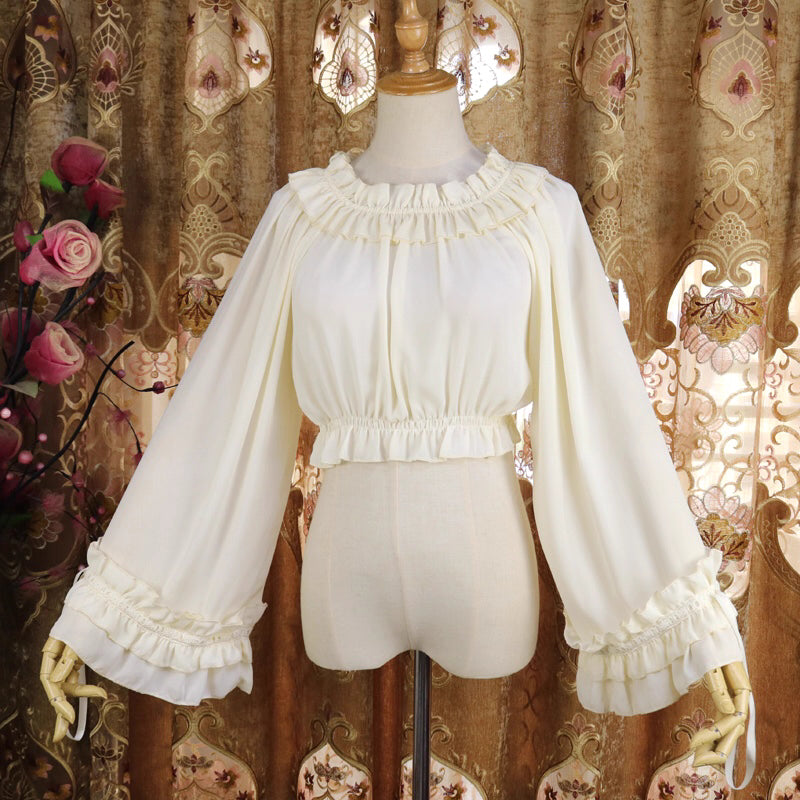 This flowing chiffon blouse combines delicate details with dramatic flared sleeves. Rendered in classic black, white, and bold red, its loose round neck design offers comfortable versatility for layering under JSKs or jumpers. The lightweight fabric and romantic silhouette create an elegant yet functional piece, perfect for adding dynamic movement and vintage charm to both sweet and Gothic Lolita coordinations.