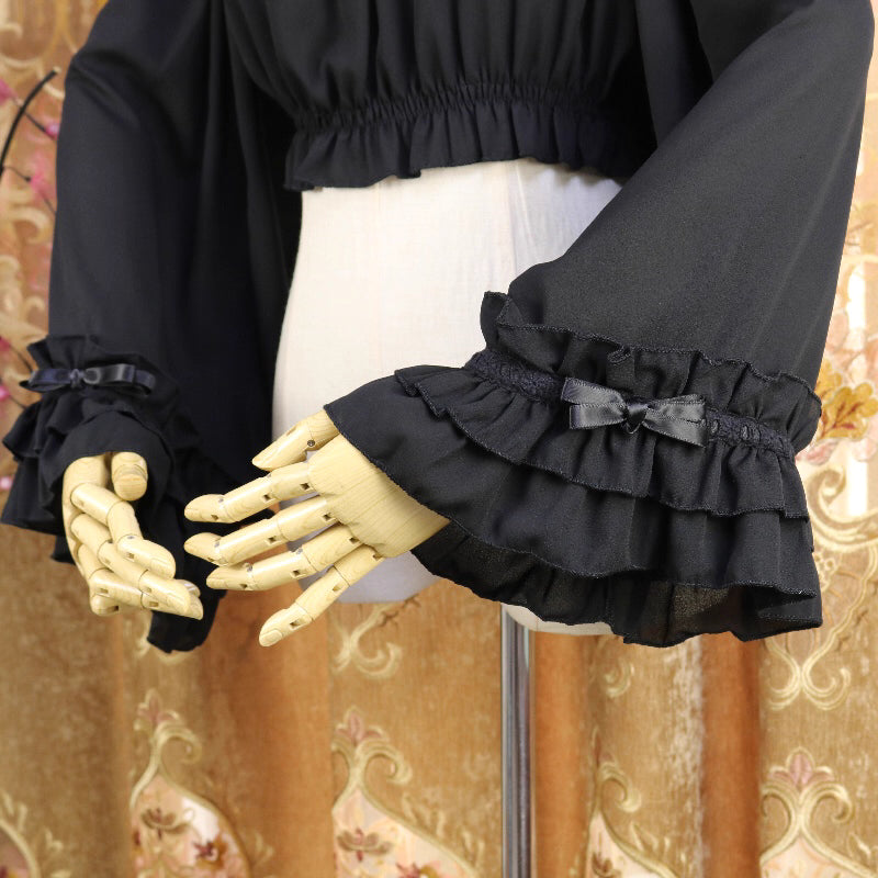This flowing chiffon blouse combines delicate details with dramatic flared sleeves. Rendered in classic black, white, and bold red, its loose round neck design offers comfortable versatility for layering under JSKs or jumpers. The lightweight fabric and romantic silhouette create an elegant yet functional piece, perfect for adding dynamic movement and vintage charm to both sweet and Gothic Lolita coordinations.