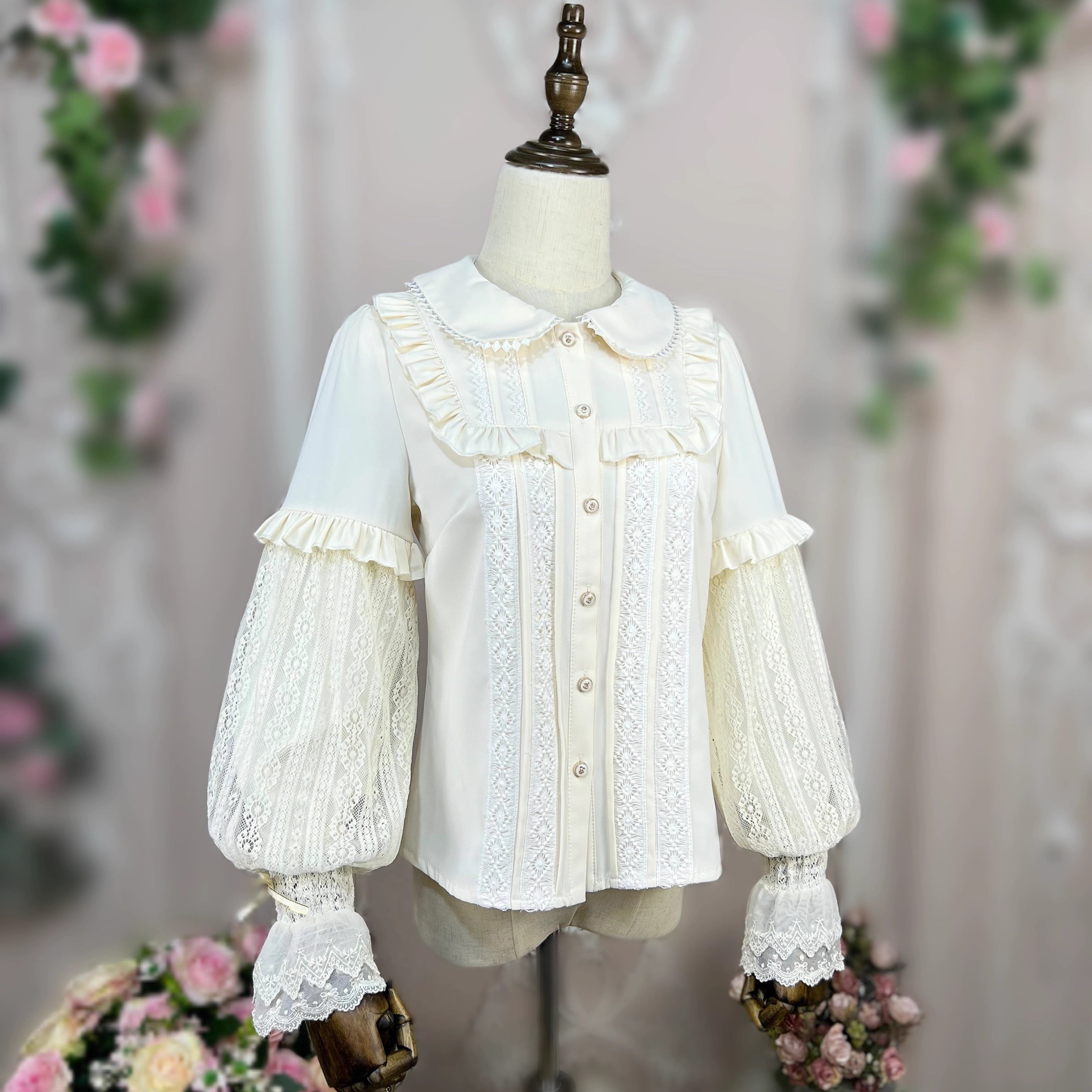 This elegant Lolita blouse combines a classic doll collar with soft bishop sleeves, creating a timeless silhouette. Designed with delicate details and a tailored fit, it offers versatile layering under jumpers or dresses. The refined design balances vintage charm and modern sweetness, perfect for adding romantic sophistication to both classic and sweet Lolita coordinates.