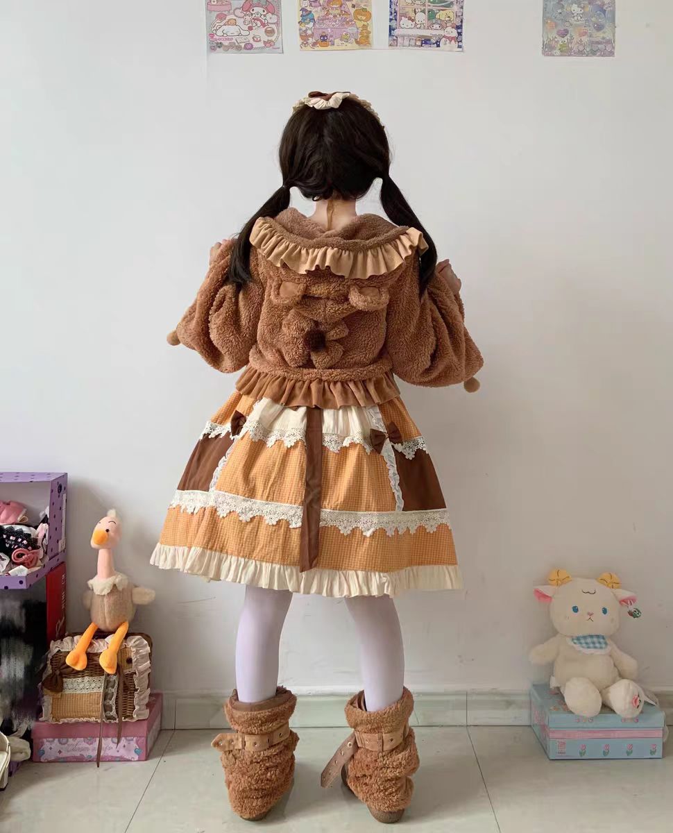 This Lolita Plush Coat in black, white, and brown tones is designed to bring both warmth and sweetness to your autumn and winter wardrobe. Made with thick plush fabric, it offers cozy comfort while maintaining a cute, doll-like charm. The short silhouette enhances a playful look, making it easy to pair with Lolita dresses or casual outfits. Perfect for daily wear, tea parties, or outdoor gatherings, this coat balances practicality with the whimsical spirit of Lolita fashion.