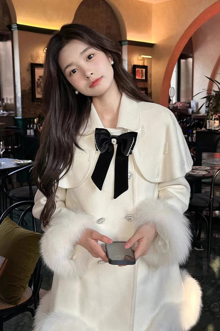 Blending whimsy with elegance, this cape coat transforms classic Lolita charm into a versatile outerwear piece. The playful rabbit ears and delicate bow contrast the monochrome palette, creating a striking balance between sweetness and sophistication. Designed with a flowing silhouette and single-row button closure, it offers effortless layering for cool days—perfect for adding a touch of fantasy to both casual and formal Lolita coordinates.