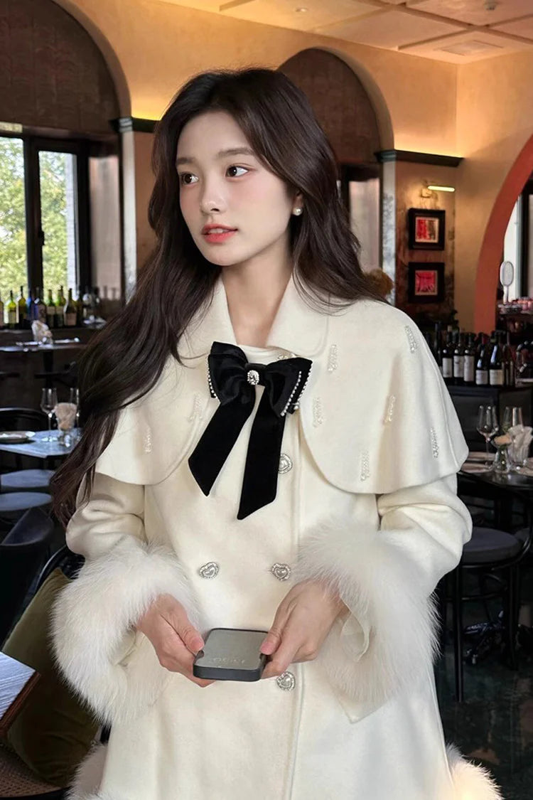 Blending whimsy with elegance, this cape coat transforms classic Lolita charm into a versatile outerwear piece. The playful rabbit ears and delicate bow contrast the monochrome palette, creating a striking balance between sweetness and sophistication. Designed with a flowing silhouette and single-row button closure, it offers effortless layering for cool days—perfect for adding a touch of fantasy to both casual and formal Lolita coordinates.