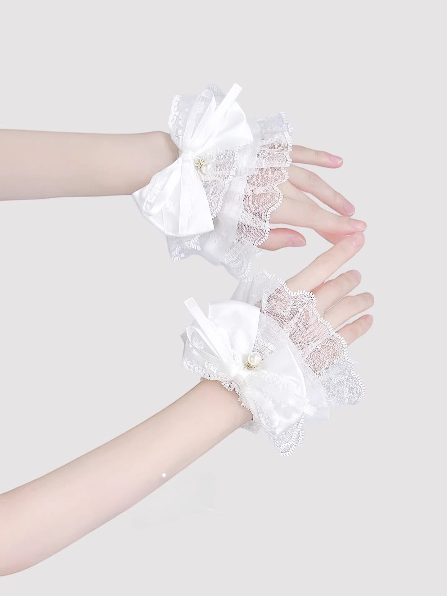 Inspired by the delicate elegance of Lolita fashion, these wrist cuffs blend fantasy and femininity. Adorned with intricate lace, dainty pearls, and a charming bow accent, they embody romantic innocence. Crafted from soft materials for all-day comfort, they offer a subtle yet enchanting touch to JK uniforms or Lolita coordinates, perfect for expressing timeless sweetness and grace.