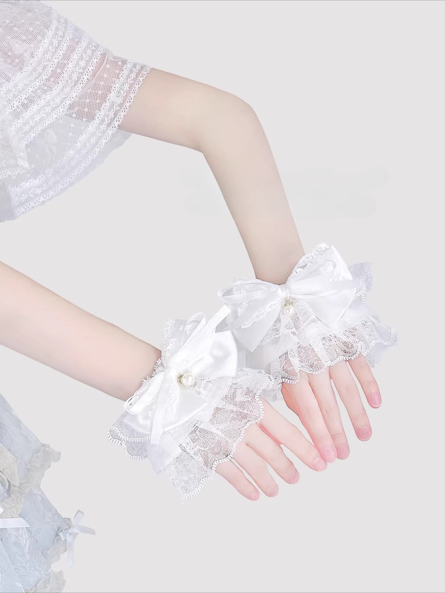 Inspired by the delicate elegance of Lolita fashion, these wrist cuffs blend fantasy and femininity. Adorned with intricate lace, dainty pearls, and a charming bow accent, they embody romantic innocence. Crafted from soft materials for all-day comfort, they offer a subtle yet enchanting touch to JK uniforms or Lolita coordinates, perfect for expressing timeless sweetness and grace.