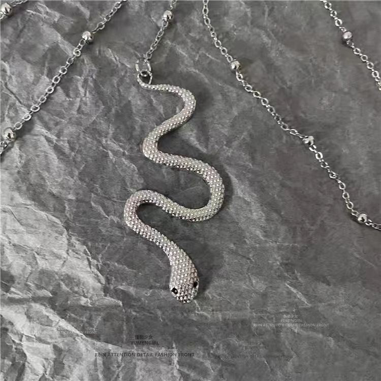 This Dark Lolita Cyberpunk Gothic Snake Necklace blends mysterious elegance with bold punk energy. The unique serpent design symbolizes strength and rebellion, while its sleek metallic finish adds a futuristic Y2K edge. Perfect for Gothic, punk, or alternative styles, it enhances any outfit with a touch of daring attitude. Ideal for parties, concerts, or daily wear for girls who love dark aesthetics and statement accessories.