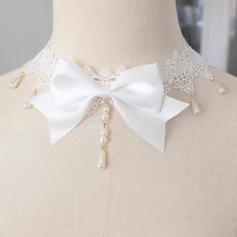 This Lolita Lace Bowknot Pearl Choker Necklace is designed as a versatile accessory to elevate any Lolita look. Featuring delicate lace, dainty pearls, and a sweet bowknot centerpiece, it strikes a balance between elegance and cuteness. The soft yet ornate design makes it perfect for pairing with dresses, from sweet styles to gothic ensembles. Ideal for tea parties, photoshoots, or daily styling, this choker adds a refined touch of Lolita charm.
