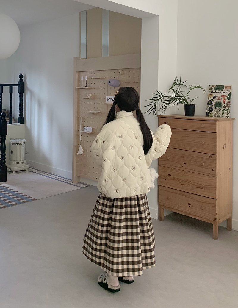 Inspired by cozy autumn days, this Chestnut skirt features an original plaid pattern in rich brown and coffee tones. Designed with a classic A-line silhouette, it effortlessly skims the body for a flattering, timeless look. Crafted from a warm and textured wool-blend fabric, it combines vintage charm with modern comfort. This versatile piece is created to be a staple in your winter wardrobe, perfect for adding a touch of rustic, intellectual elegance to any casual outing.