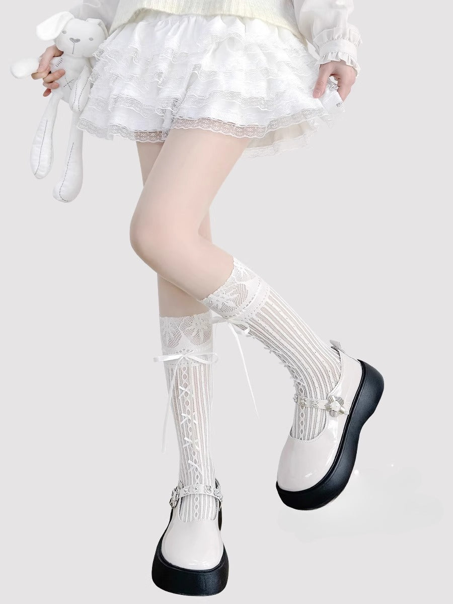 Inspired by the delicate elegance of ballet and vintage Lolita fashion, these mid-calf socks blend romance with playful charm. Sheer cream fabric adorned with intricate lace and a dainty bow tie detail creates a soft, feminine aesthetic. Perfect for pairing with Mary Jane shoes, they capture the timeless innocence of balletcore style while offering lightweight comfort for summer wear.