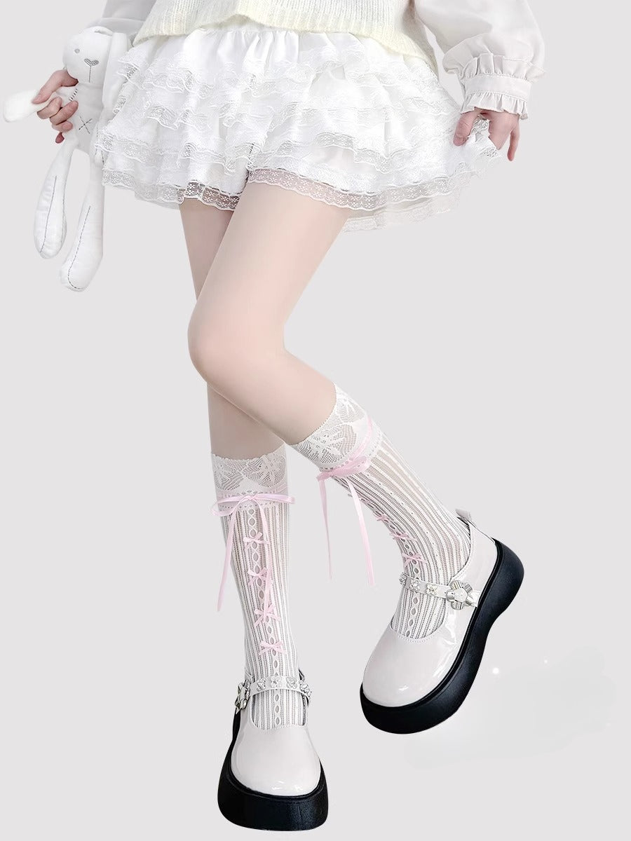 Inspired by the delicate elegance of ballet and vintage Lolita fashion, these mid-calf socks blend romance with playful charm. Sheer cream fabric adorned with intricate lace and a dainty bow tie detail creates a soft, feminine aesthetic. Perfect for pairing with Mary Jane shoes, they capture the timeless innocence of balletcore style while offering lightweight comfort for summer wear.