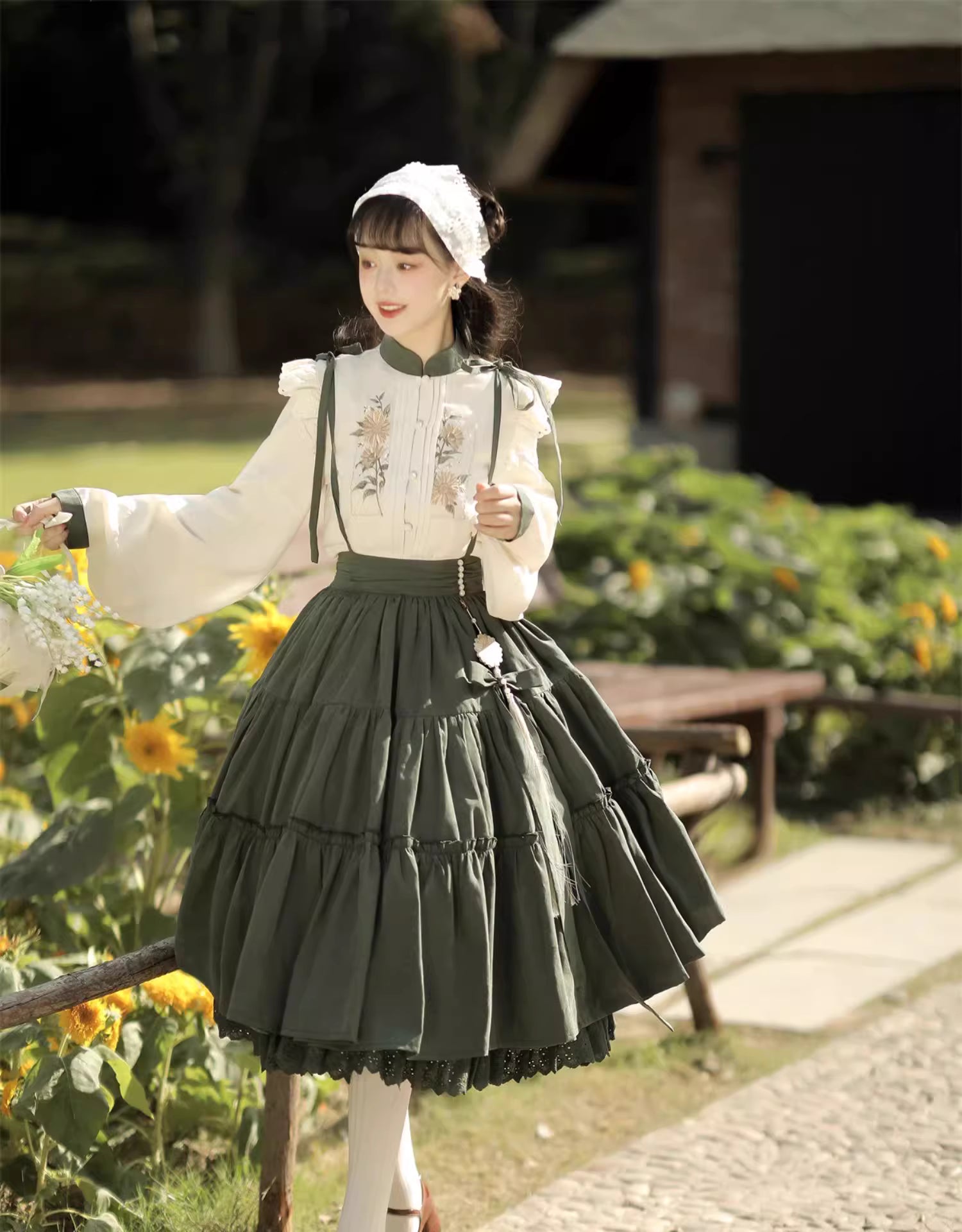 This Green Sunflower Embroidery Lolita Set blends the elegance of Hanfu-inspired details with the sweetness of classic Lolita fashion. The delicate sunflower embroidery brings a fresh pastoral charm, while the layered JSK and long-sleeve blouse create a refined silhouette. Designed for comfort and beauty, it is perfect for spring and autumn wear. Whether for tea parties, garden walks, or seasonal gatherings, this set captures a graceful harmony of tradition and modern Lolita style.