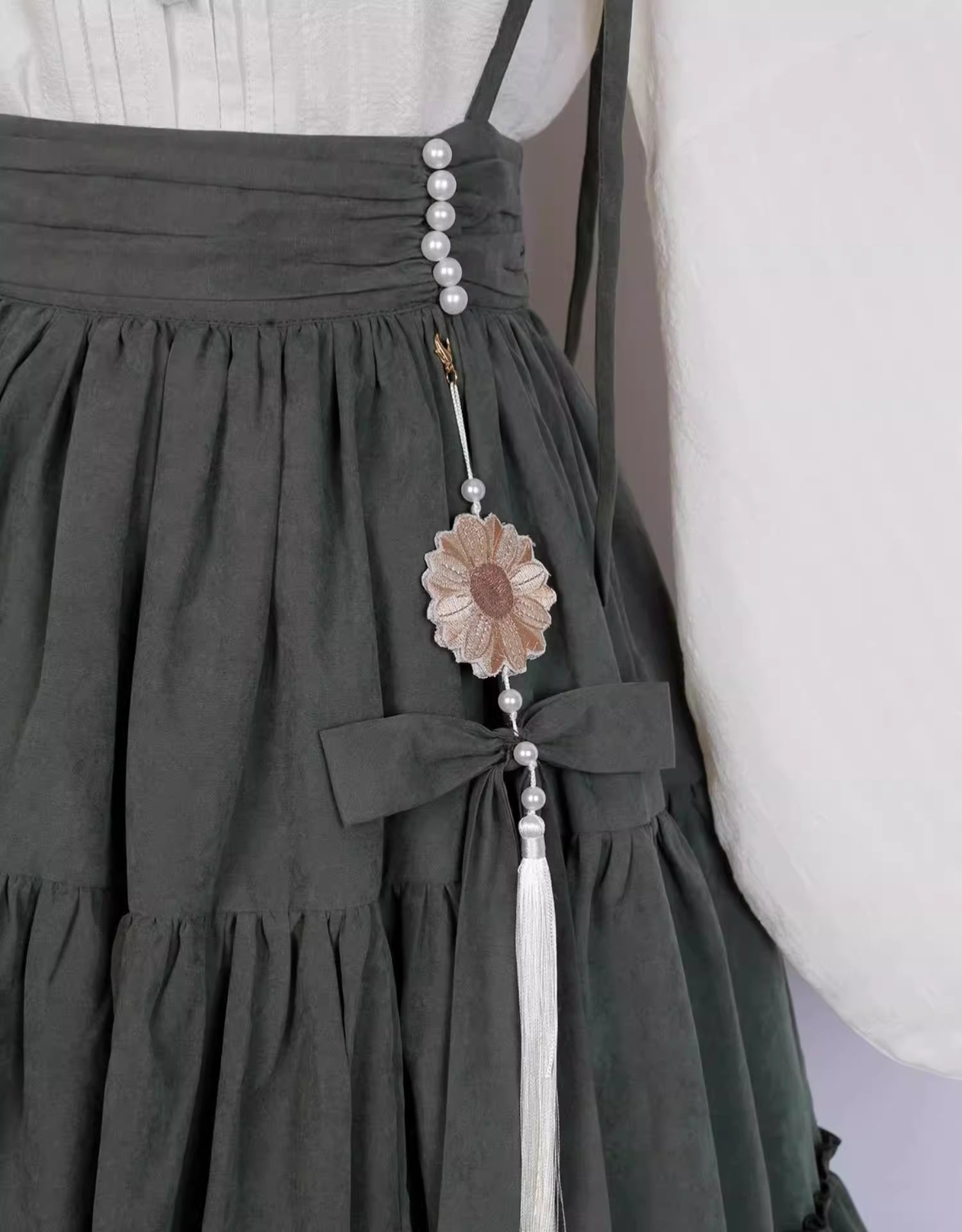 This Green Sunflower Embroidery Lolita Set blends the elegance of Hanfu-inspired details with the sweetness of classic Lolita fashion. The delicate sunflower embroidery brings a fresh pastoral charm, while the layered JSK and long-sleeve blouse create a refined silhouette. Designed for comfort and beauty, it is perfect for spring and autumn wear. Whether for tea parties, garden walks, or seasonal gatherings, this set captures a graceful harmony of tradition and modern Lolita style.