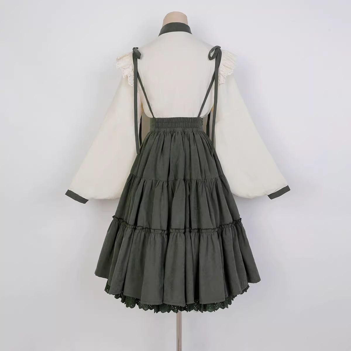 This Green Sunflower Embroidery Lolita Set blends the elegance of Hanfu-inspired details with the sweetness of classic Lolita fashion. The delicate sunflower embroidery brings a fresh pastoral charm, while the layered JSK and long-sleeve blouse create a refined silhouette. Designed for comfort and beauty, it is perfect for spring and autumn wear. Whether for tea parties, garden walks, or seasonal gatherings, this set captures a graceful harmony of tradition and modern Lolita style.