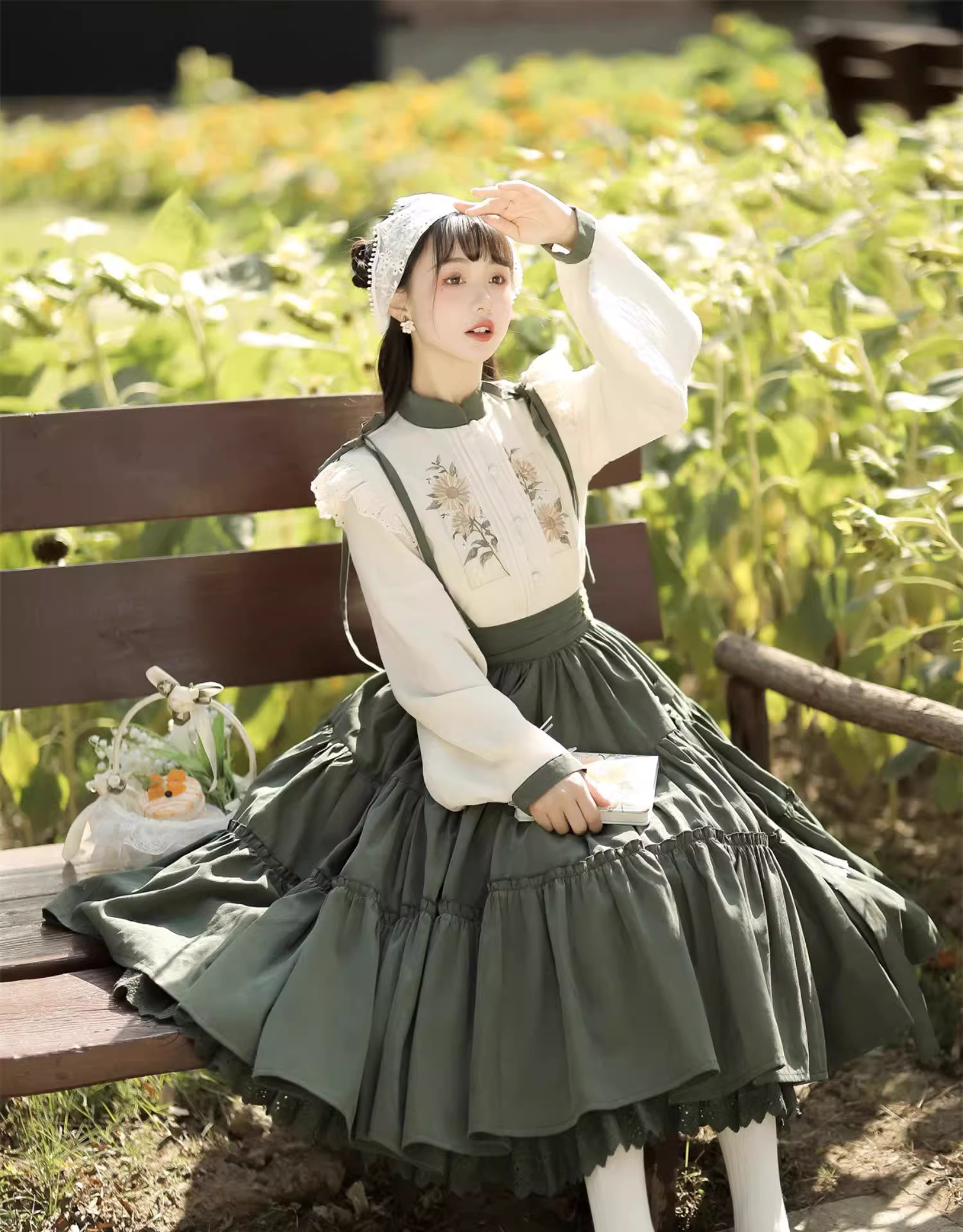This Green Sunflower Embroidery Lolita Set blends the elegance of Hanfu-inspired details with the sweetness of classic Lolita fashion. The delicate sunflower embroidery brings a fresh pastoral charm, while the layered JSK and long-sleeve blouse create a refined silhouette. Designed for comfort and beauty, it is perfect for spring and autumn wear. Whether for tea parties, garden walks, or seasonal gatherings, this set captures a graceful harmony of tradition and modern Lolita style.
