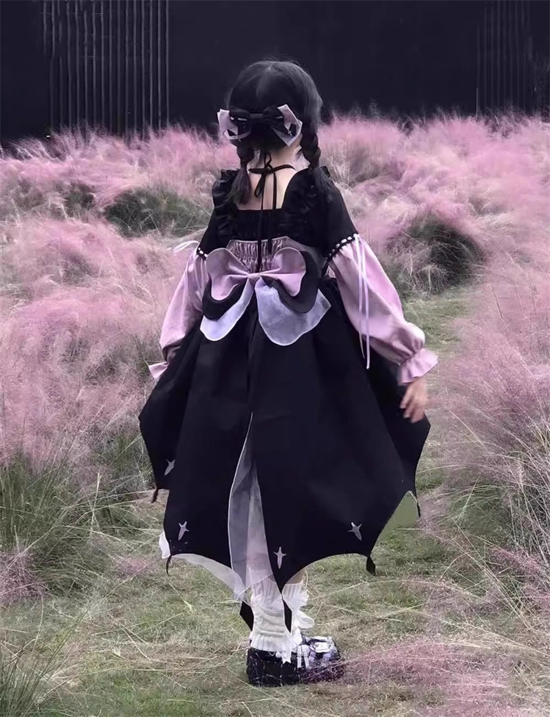 This Black Pink Cute Lolita JSK Dress blends sweet Lolita charm with a playful little witch aesthetic. Designed as a suspender-style JSK, it features a flattering silhouette suitable for autumn and winter wear. The contrasting black and pink tones create a whimsical yet elegant look, while delicate ruffles and bow accents enhance girlish appeal. Perfect for tea parties, cosplay, or seasonal outings, this dress captures the magical essence of Lolita fashion with a charming, mystical twist.