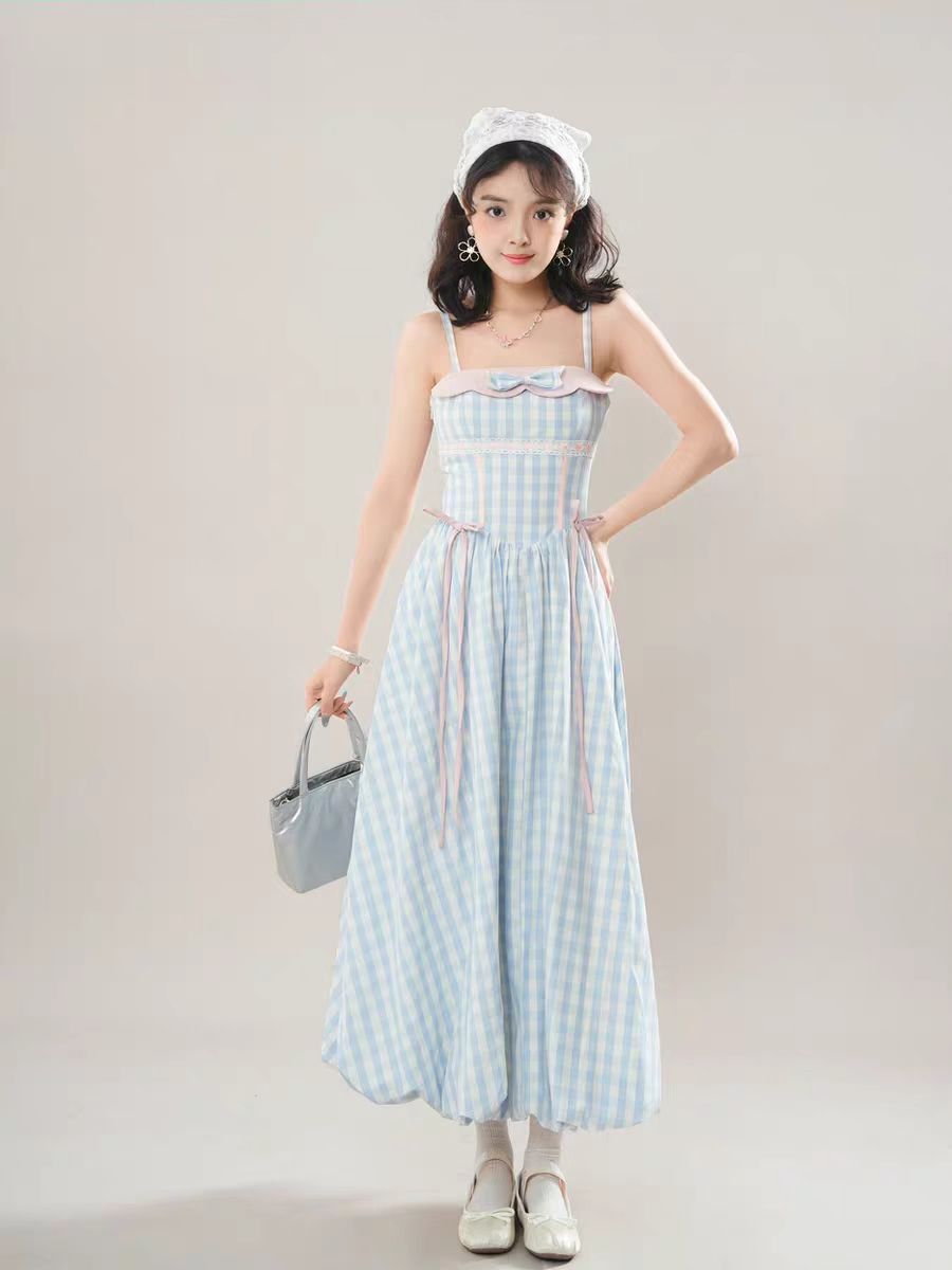 The Blue Plaid JSK Long Dress captures the timeless charm of Sweet Lolita fashion with a touch of classic vintage style. Designed in a sleeveless cut, it features a soft plaid print enhanced with delicate bow accents for added sweetness. The long silhouette creates an elegant flow, balancing playfulness with refinement. Perfect for tea parties, casual outings, or special gatherings, this dress reflects both comfort and the romantic essence of Lolita fashion.