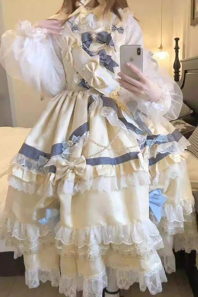 "Inspired by the opulence of royal courts and the delicate beauty of gilded artistry, this dress transforms classic Lolita elegance into a vision of luxury. The gold-toned palette evokes a sense of grandeur, while intricate lace and cascading ruffles reflect both tradition and fantasy."