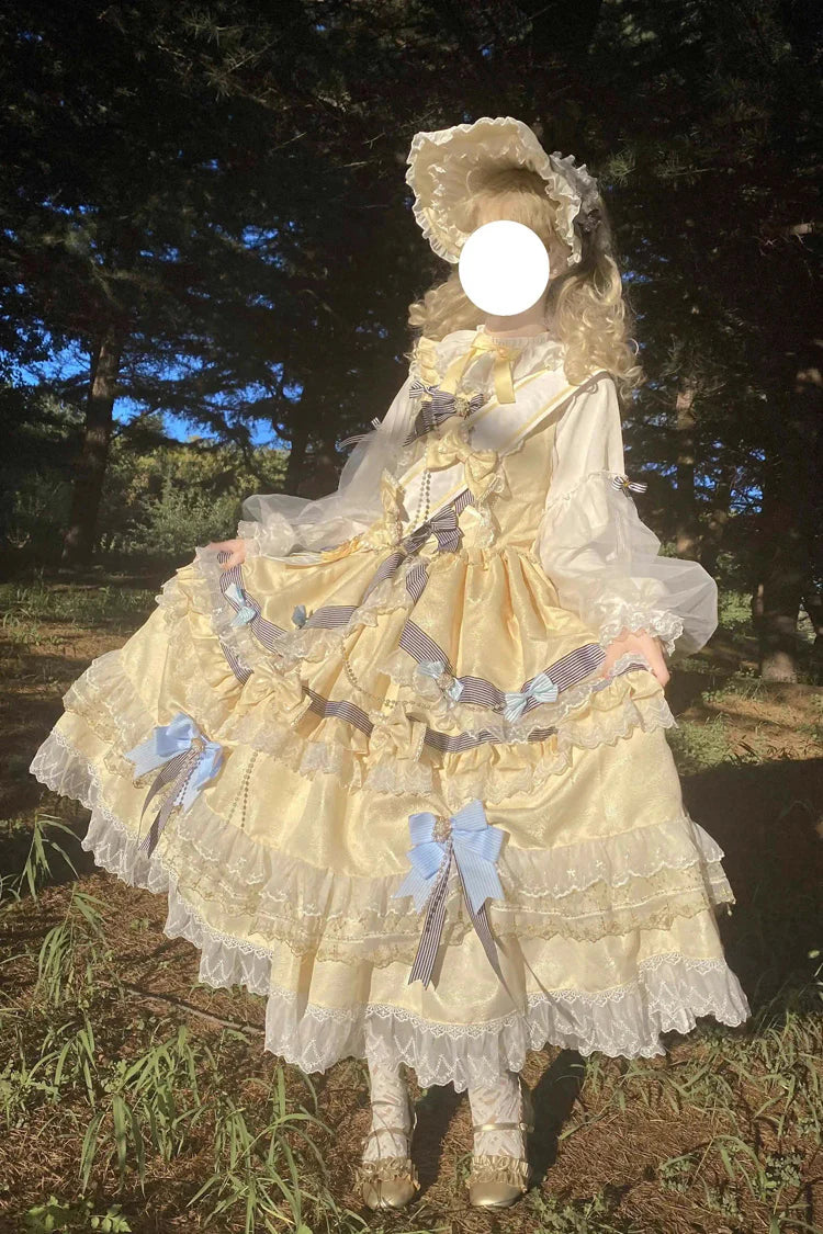 "Inspired by the opulence of royal courts and the delicate beauty of gilded artistry, this dress transforms classic Lolita elegance into a vision of luxury. The gold-toned palette evokes a sense of grandeur, while intricate lace and cascading ruffles reflect both tradition and fantasy."