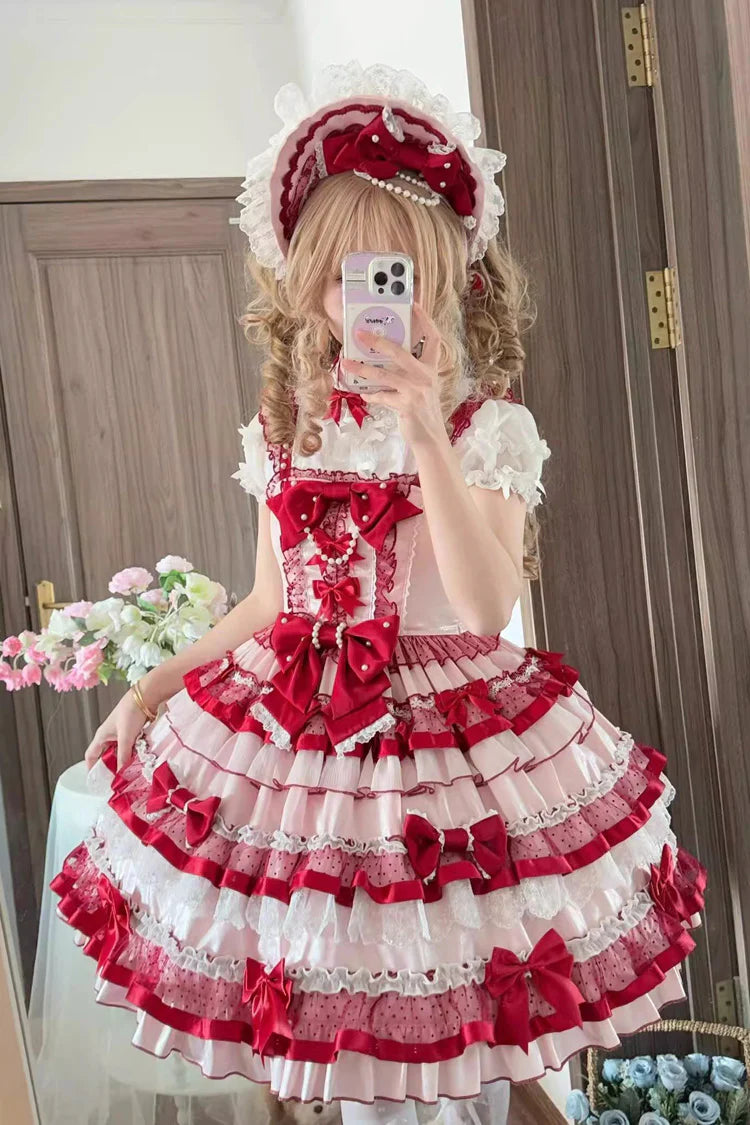 The Red “Ribbon Berries” JSK Dress is designed to capture the joyful charm of Sweet Lolita fashion. Featuring a sleeveless cut with cascading ruffles, delicate lace, and playful bowknots, it creates a lively, romantic silhouette. The berry-inspired accents add a festive, fresh touch, making the dress perfect for tea parties, picnics, or seasonal gatherings. Balancing sweetness with elegance, it reflects the whimsical and feminine essence of classic Lolita style.