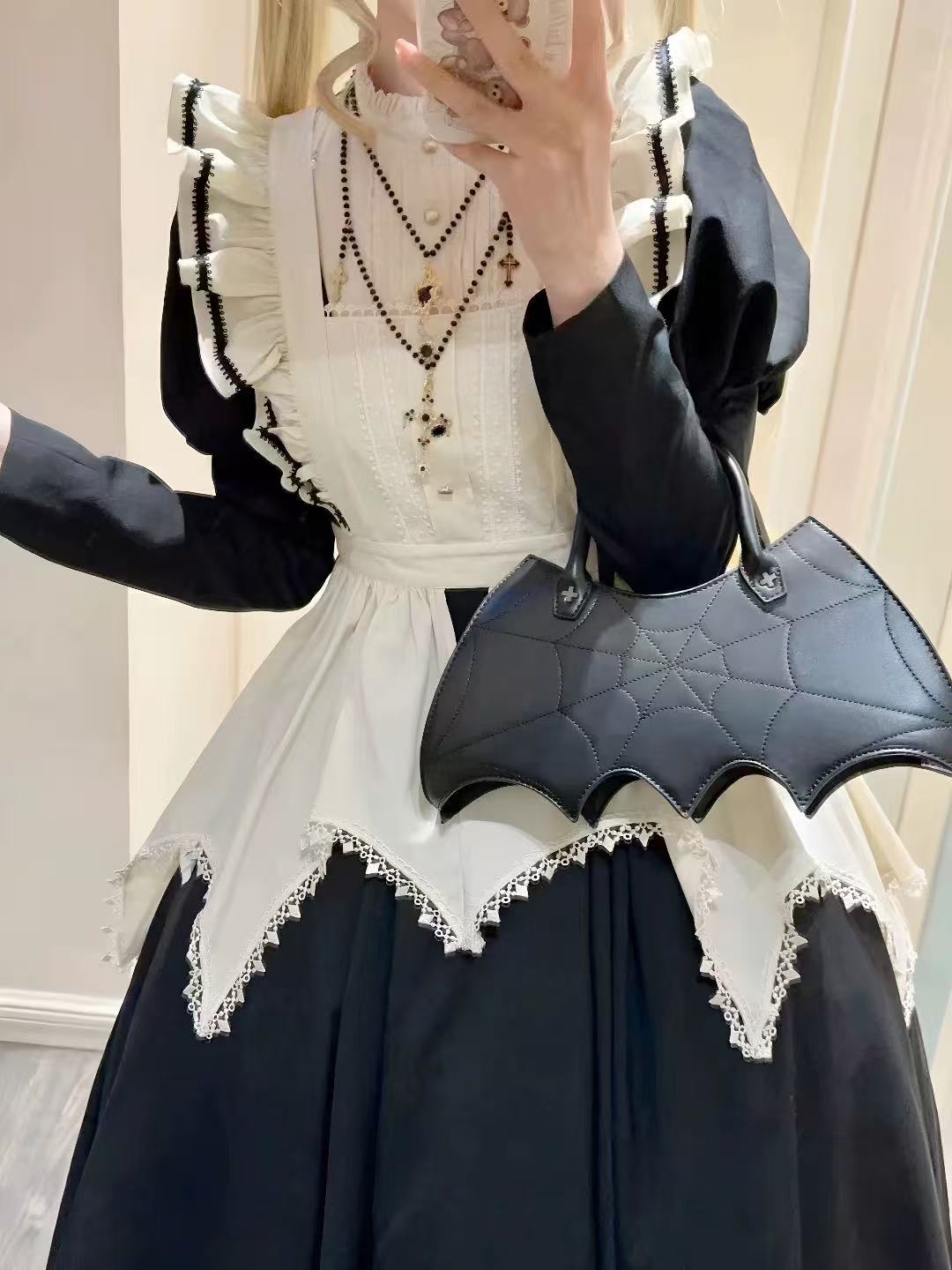 Design Concept:
This Gothic Lolita black nun style maid outfit combines dark elegance with cosplay charm, featuring puff sleeves for a dramatic effect. Product Details: The set includes an apron and a long sleeve dress, creating a complete ensemble perfect for cosplay, themed events, or Halloween occasions.