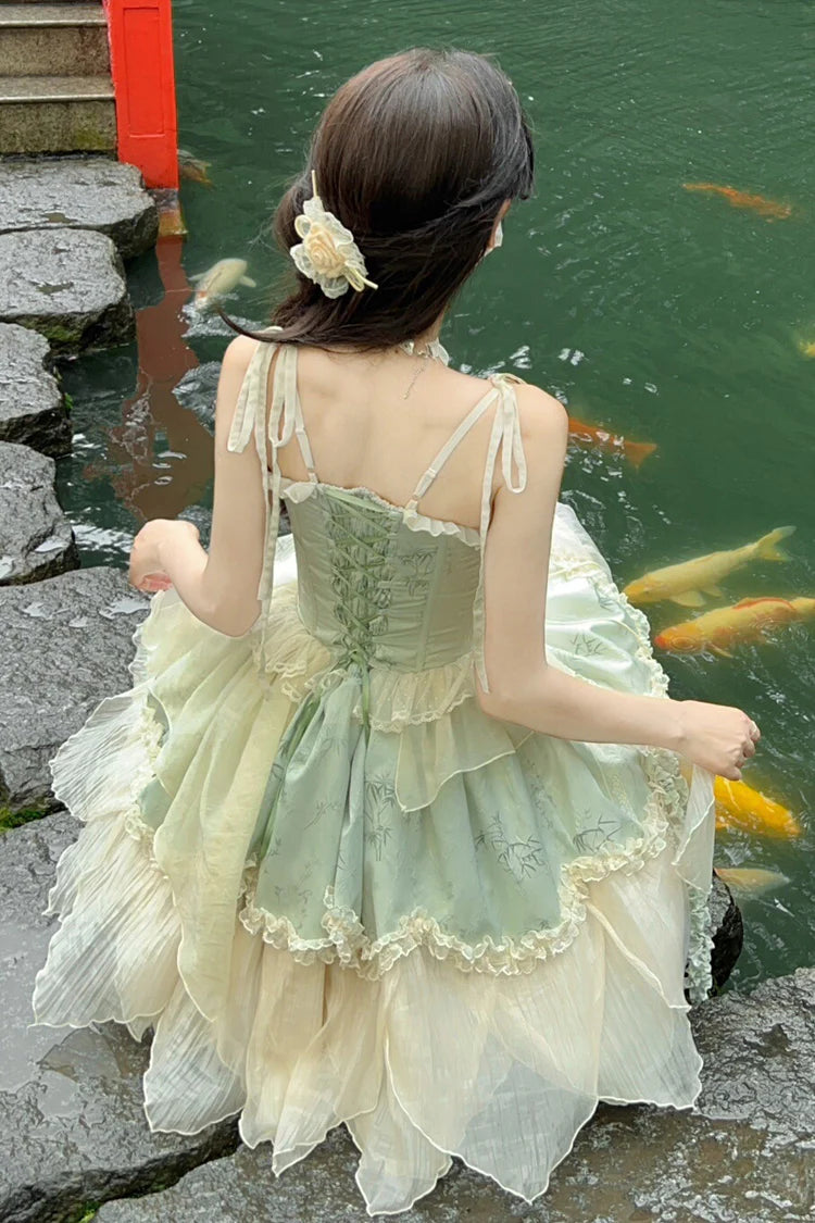 Design Concept: 
This Sweet Lolita green sleeveless jacquard JSK dress features ruffles, bowknot lace, and an irregular hem, blending sweet elegance with Chinese ballet-inspired charm. The soft green tone adds a refreshing and graceful feel, perfect for a unique Lolita style. The product includes the main dress, a detachable rose for the waist, a detachable rose for the chest, a pair of detachable wrist sleeves, and a matching floral hair accessory, forming a complete five-piece set.