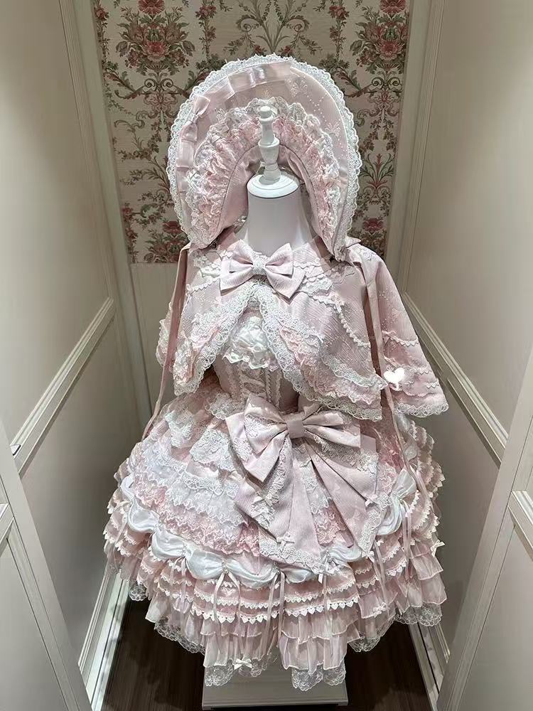 Design Concept:
This Sweet Lolita pink lace trimmed strappy JSK princess dress set embodies a delicate and charming style, combining soft pink tones with elegant lace details for a dreamy Lolita look. Product Details: The set includes a pink dress, a pin-on bow, an official matching inner petticoat, and a coordinating cape, creating a complete and enchanting outfit perfect for special occasions or Lolita fashion events.