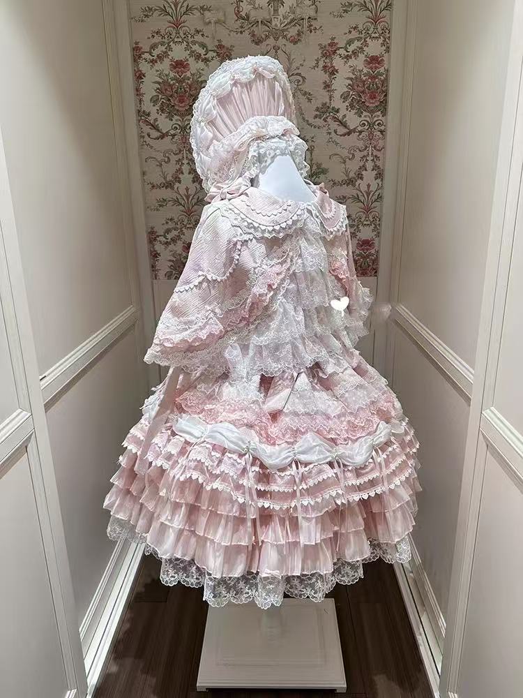 Design Concept:
This Sweet Lolita pink lace trimmed strappy JSK princess dress set embodies a delicate and charming style, combining soft pink tones with elegant lace details for a dreamy Lolita look. Product Details: The set includes a pink dress, a pin-on bow, an official matching inner petticoat, and a coordinating cape, creating a complete and enchanting outfit perfect for special occasions or Lolita fashion events.