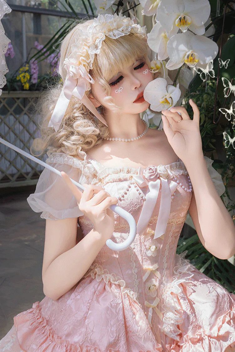 Design Concept: 
This Sweet Lolita pink sleeveless JSK dress features multi-layered ruffles, delicate lace, and charming bow details, creating a dreamy and elegant princess style. The soft pink tone adds sweetness, making it perfect for a refined Lolita look. The product includes a dress, a front chest accessory, and a back bow with a trailing tail, offering a coordinated and enchanting outfit.