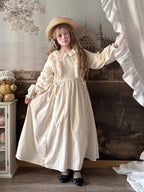 Inspired by romantic French countryside aesthetics, this dress combines delicate embroidery with soft tiered ruffles and voluminous bubble sleeves. The loose high-waist silhouette flows gracefully in lightweight fabric, while intricate floral motifs and a warm beige palette evoke nostalgic elegance. Perfect for autumn gatherings, it blends vintage charm with effortless comfort—a poetic homage to pastoral beauty and timeless femininity.