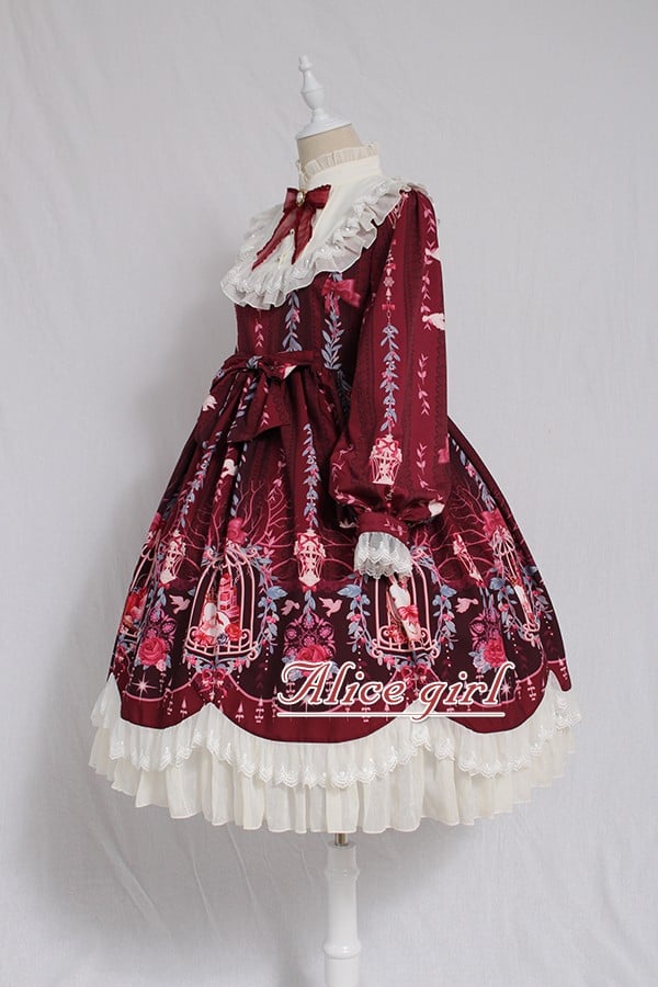 The Red Classic Lolita OP Dress is designed to express timeless elegance with a sweet touch. Featuring long sleeves for autumn and winter wear, it is adorned with delicate lace and charming bow tie details that highlight femininity. The fitted bodice with lace-up accents creates a graceful silhouette, while the rich red tone conveys warmth and sophistication. Perfect for tea parties, gatherings, or seasonal occasions, this dress captures the romantic spirit of classic Lolita fashion.