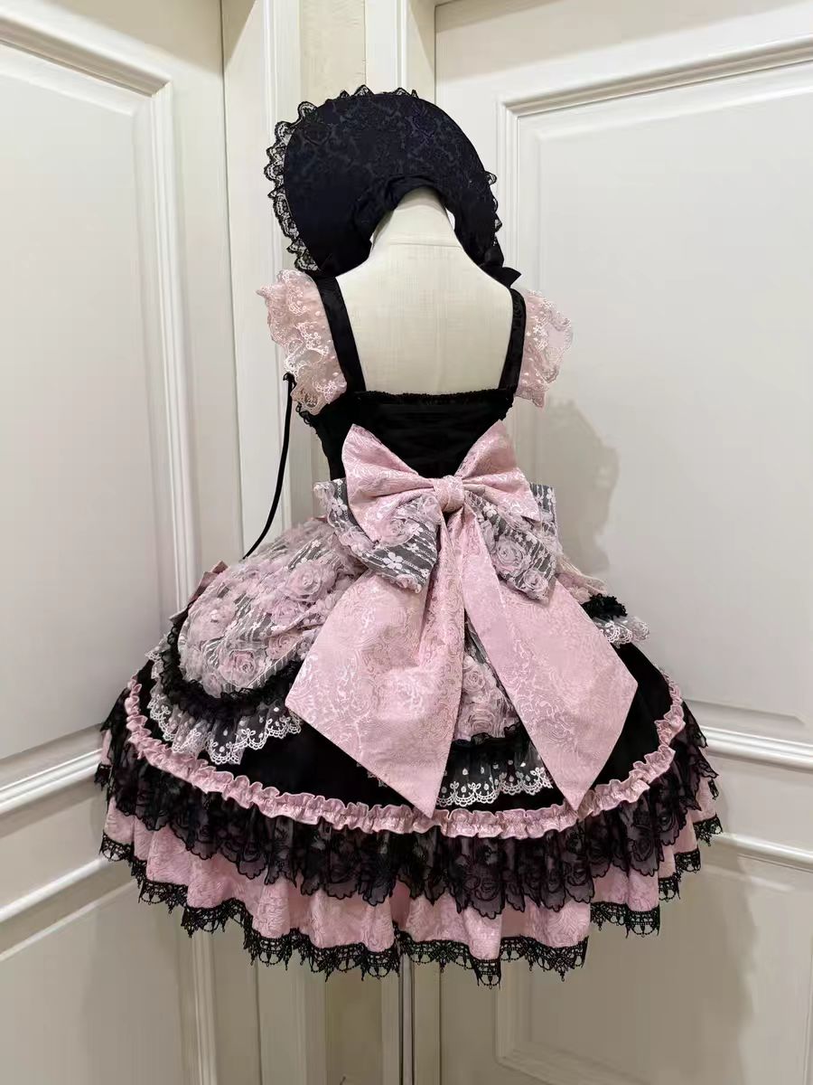 The Black Pink Ballet Lolita JSK Dress is crafted to express elegance with a playful, dance-inspired charm. Featuring a sleeveless cut, layered ruffles, and delicate lace, it creates a graceful silhouette reminiscent of a ballerina’s costume. The lace-up detail ensures both beauty and flexibility, while bow accents add sweetness to the design. With its striking black and pink contrast, this dress is perfect for tea parties, performances, or special Lolita occasions.