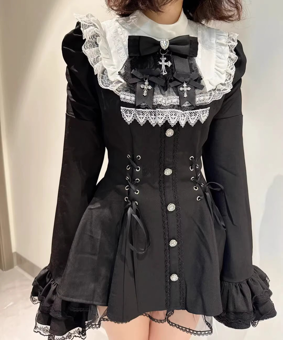 This bell-sleeve Gothic Lolita dress combines dark elegance with petite-friendly proportions. Rendered in stark black and white, its A-line silhouette and delicate lace details create a whimsical yet edgy aesthetic. The dramatic sleeves and tailored waist flatter smaller frames, making it ideal for coordinations blending Japanese-inspired sweetness with timeless Gothic romance.