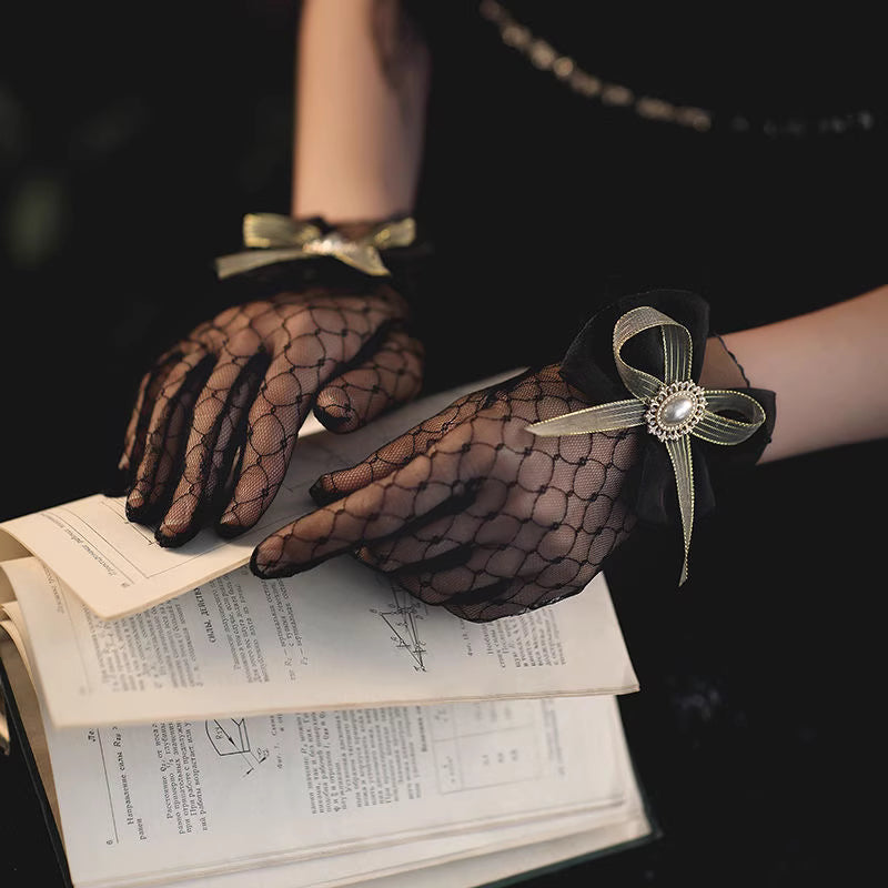 These gothic Lolita lace gloves are crafted with delicate sheer mesh and floral lace trim, blending elegance with sensual charm. The black design adds a mysterious gothic touch, while the thin fabric creates a graceful silhouette. Perfect for weddings, qipao styling, Halloween cosplay, or themed photo shoots, these gloves complete any Lolita or bridal-inspired outfit with timeless allure.