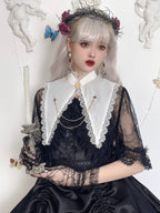 Design Concept:
This Gothic Lolita set in black and white features a pointed shell blouse with fake collar, brooch, and decorative chain, combining dark elegance with a refined subcultural aesthetic. Perfect for daily wear, tea parties, or themed gatherings, this set offers a polished Lolita look with intricate detailing.
