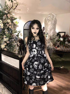 Embrace dark romance in this striking Gothic mini dress, where underground subculture meets high fashion. The bold skeleton and rose hand-print design creates a haunting visual narrative against the fitted silhouette. Designed with a built-in corset bustier for waist-cinching definition, this dress accentuates your curves while making a powerful street-style statement. Lightweight yet dramatic, it transitions seamlessly from concert venues to night markets. The adjustable straps and breathable fabric ensure