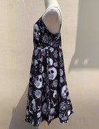 Embrace dark romance in this striking Gothic mini dress, where underground subculture meets high fashion. The bold skeleton and rose hand-print design creates a haunting visual narrative against the fitted silhouette. Designed with a built-in corset bustier for waist-cinching definition, this dress accentuates your curves while making a powerful street-style statement. Lightweight yet dramatic, it transitions seamlessly from concert venues to night markets. The adjustable straps and breathable fabric ensure