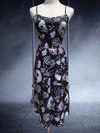 Embrace dark romance in this striking Gothic mini dress, where underground subculture meets high fashion. The bold skeleton and rose hand-print design creates a haunting visual narrative against the fitted silhouette. Designed with a built-in corset bustier for waist-cinching definition, this dress accentuates your curves while making a powerful street-style statement. Lightweight yet dramatic, it transitions seamlessly from concert venues to night markets. The adjustable straps and breathable fabric ensure