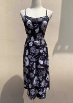 Embrace dark romance in this striking Gothic mini dress, where underground subculture meets high fashion. The bold skeleton and rose hand-print design creates a haunting visual narrative against the fitted silhouette. Designed with a built-in corset bustier for waist-cinching definition, this dress accentuates your curves while making a powerful street-style statement. Lightweight yet dramatic, it transitions seamlessly from concert venues to night markets. The adjustable straps and breathable fabric ensure