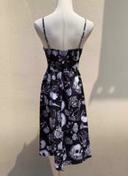 Embrace dark romance in this striking Gothic mini dress, where underground subculture meets high fashion. The bold skeleton and rose hand-print design creates a haunting visual narrative against the fitted silhouette. Designed with a built-in corset bustier for waist-cinching definition, this dress accentuates your curves while making a powerful street-style statement. Lightweight yet dramatic, it transitions seamlessly from concert venues to night markets. The adjustable straps and breathable fabric ensure