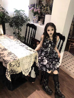 Embrace dark romance in this striking Gothic mini dress, where underground subculture meets high fashion. The bold skeleton and rose hand-print design creates a haunting visual narrative against the fitted silhouette. Designed with a built-in corset bustier for waist-cinching definition, this dress accentuates your curves while making a powerful street-style statement. Lightweight yet dramatic, it transitions seamlessly from concert venues to night markets. The adjustable straps and breathable fabric ensure