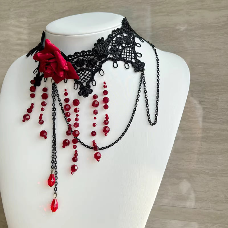 This gothic vampire Lolita choker is designed with lace, roses, and delicate tassels for a dramatic Halloween look. The striking blood drop pendant adds mystery and dark romance, while the vintage details highlight Lolita elegance. Perfect for cosplay, themed parties, or alternative fashion styling, this accessory captures the essence of gothic beauty with a hauntingly alluring charm.