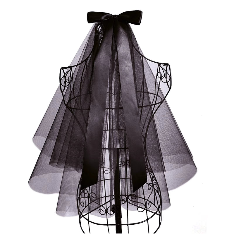 This short gothic bride veil is designed for a mysterious and dramatic Halloween style. Featuring a large bow with flowing ribbons, it blends vintage elegance with dark fantasy. The veil creates a ghostly yet stylish look, perfect for cosplay, themed parties, or photo shoots. A striking accessory that transforms any outfit into a hauntingly beautiful statement.