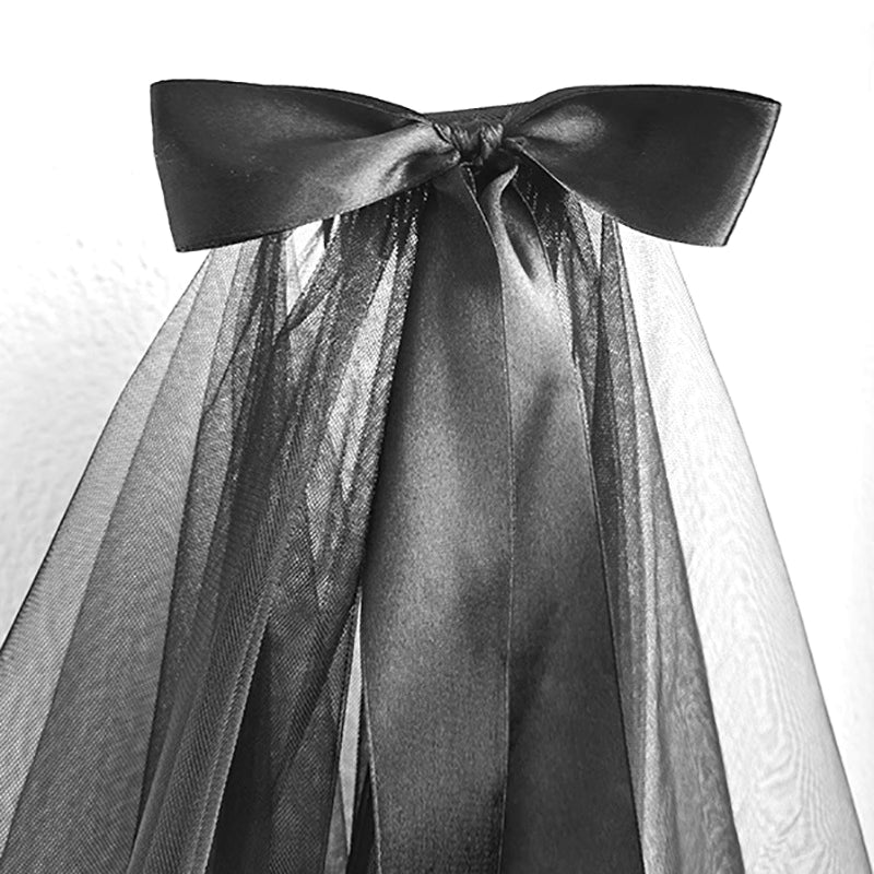 This short gothic bride veil is designed for a mysterious and dramatic Halloween style. Featuring a large bow with flowing ribbons, it blends vintage elegance with dark fantasy. The veil creates a ghostly yet stylish look, perfect for cosplay, themed parties, or photo shoots. A striking accessory that transforms any outfit into a hauntingly beautiful statement.