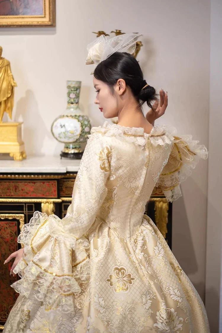 This dress is a tribute to the opulence of history, weaving together the grandeur of medieval courts and the refinement of Victorian elegance. Meticulous gold embroidery evokes royal craftsmanship, while the structured silhouette and lavish details—from lace trims to cascading skirts—celebrate timeless luxury. Designed for modern dreamers, it bridges centuries of artistry, allowing the wearer to embody a narrative where fantasy and heritage dance in harmonious splendor.